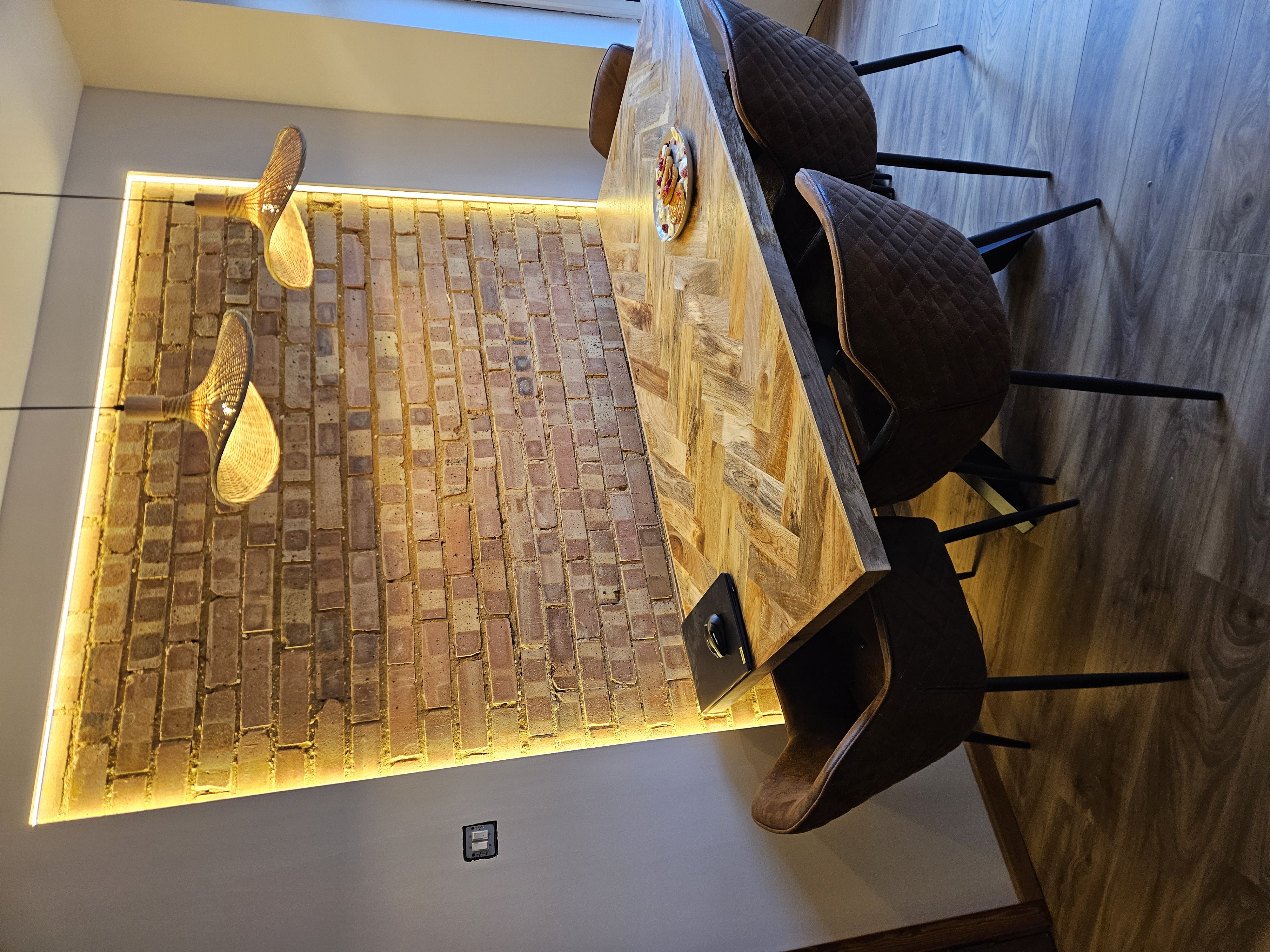Backlit brick wall and pendant lighting installation